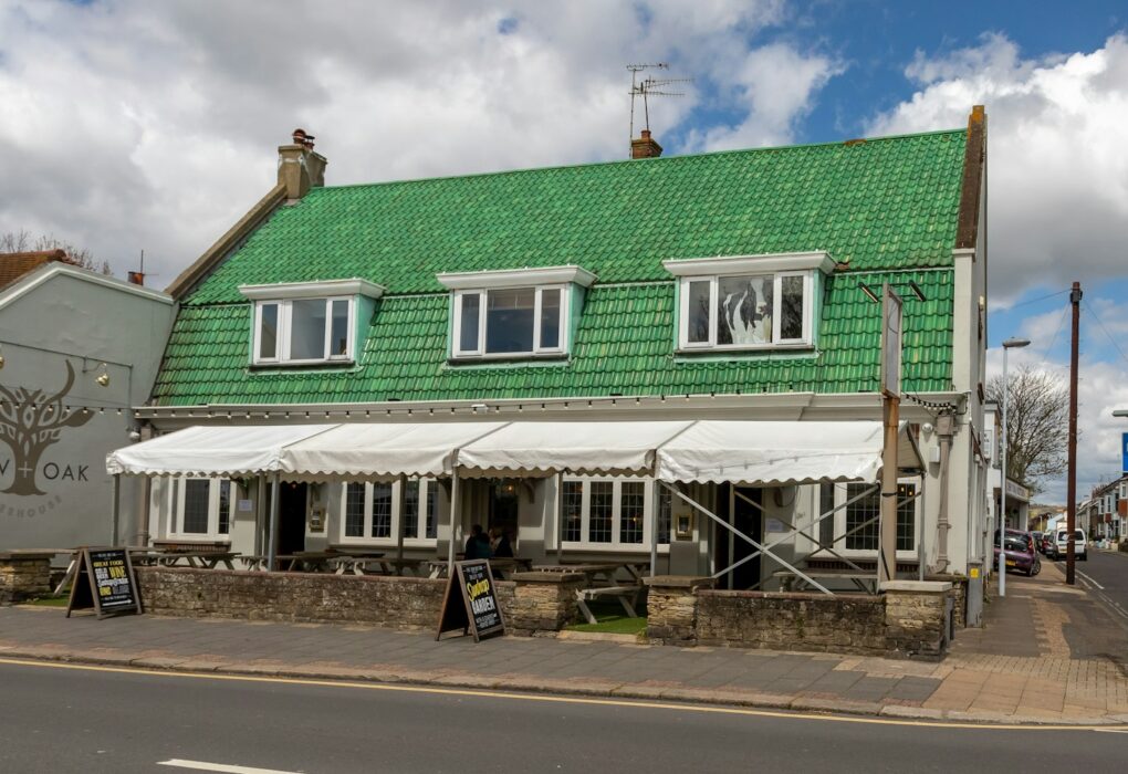 green and white wooden house under blue sky during daytime