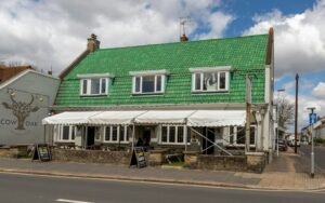 green and white wooden house under blue sky during daytime