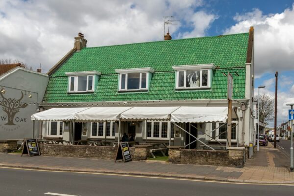 green and white wooden house under blue sky during daytime