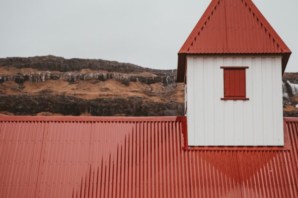 red and white building under cloudy sky during daytime
