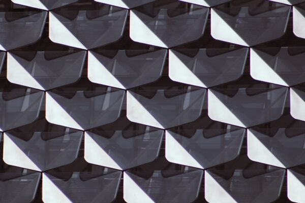 Fixing pitch distortion in tensioned fabric roof systems white and black concrete building